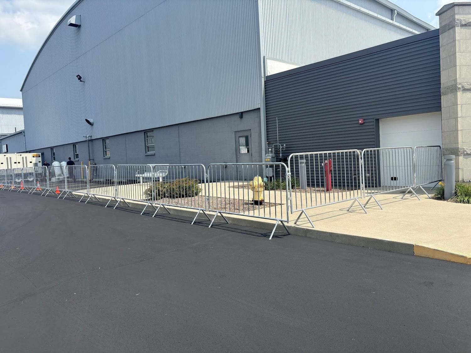 A run of crowd control barricades along the side of a building