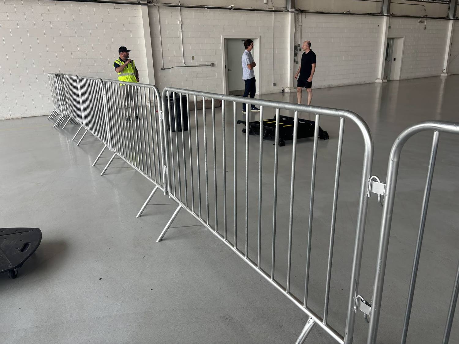 A line of crowd control barricades set inside a building for an event