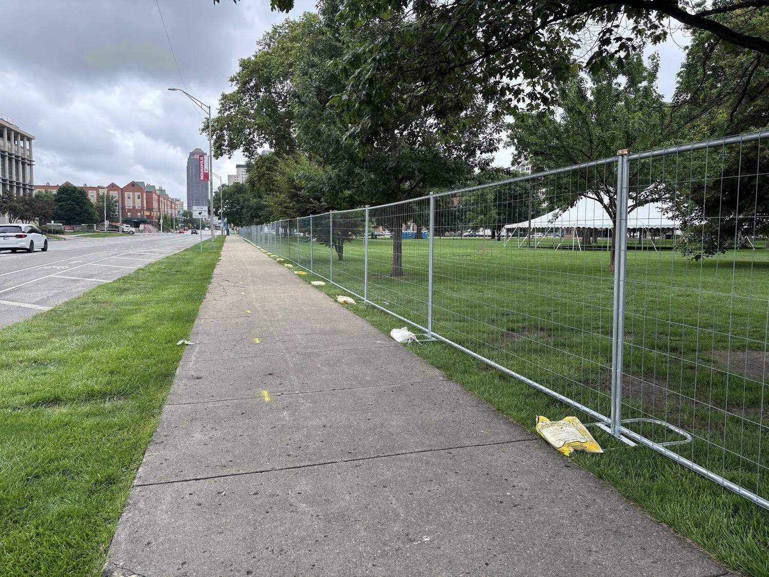 Temporary fence panels along a city sidewalk on an Indianapolis street