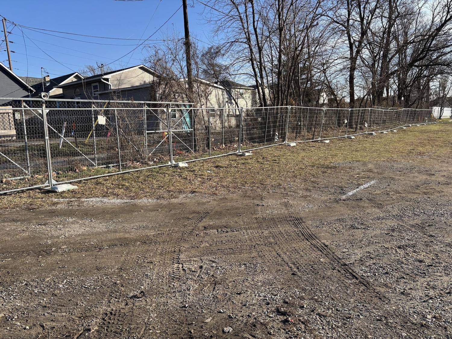 Temporary fence panels around a cleared lot in an Indianapolis neighborhood