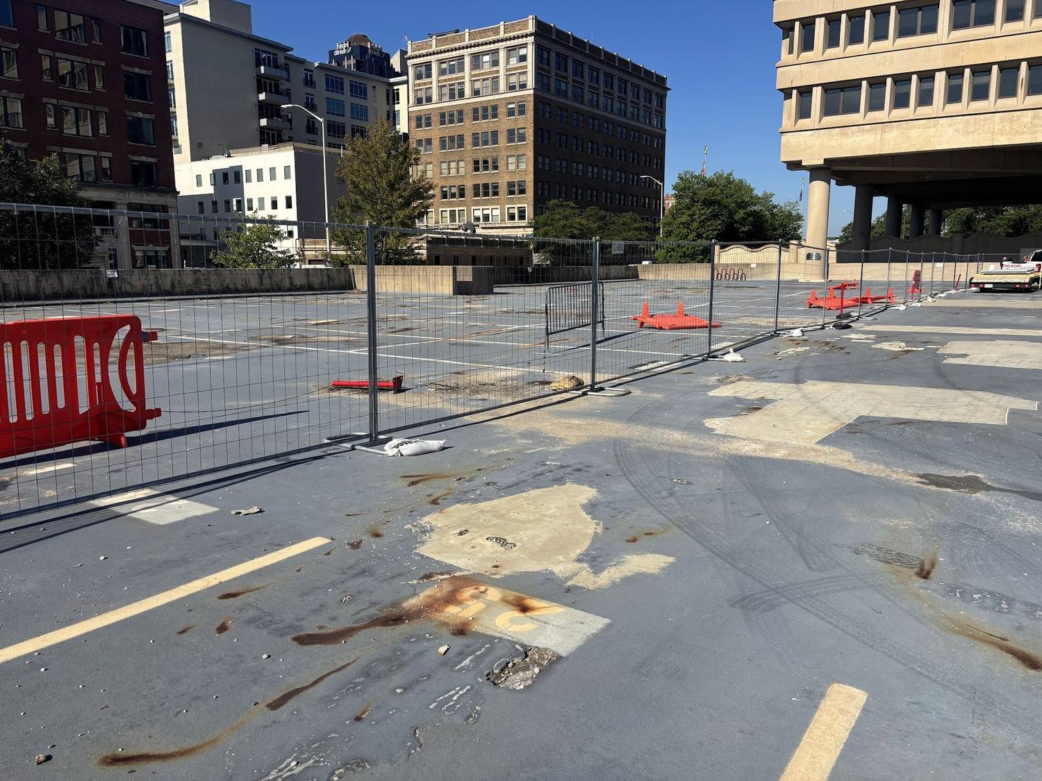 Temporary fence panels and barricades securing a lot in downtown Indianapolis