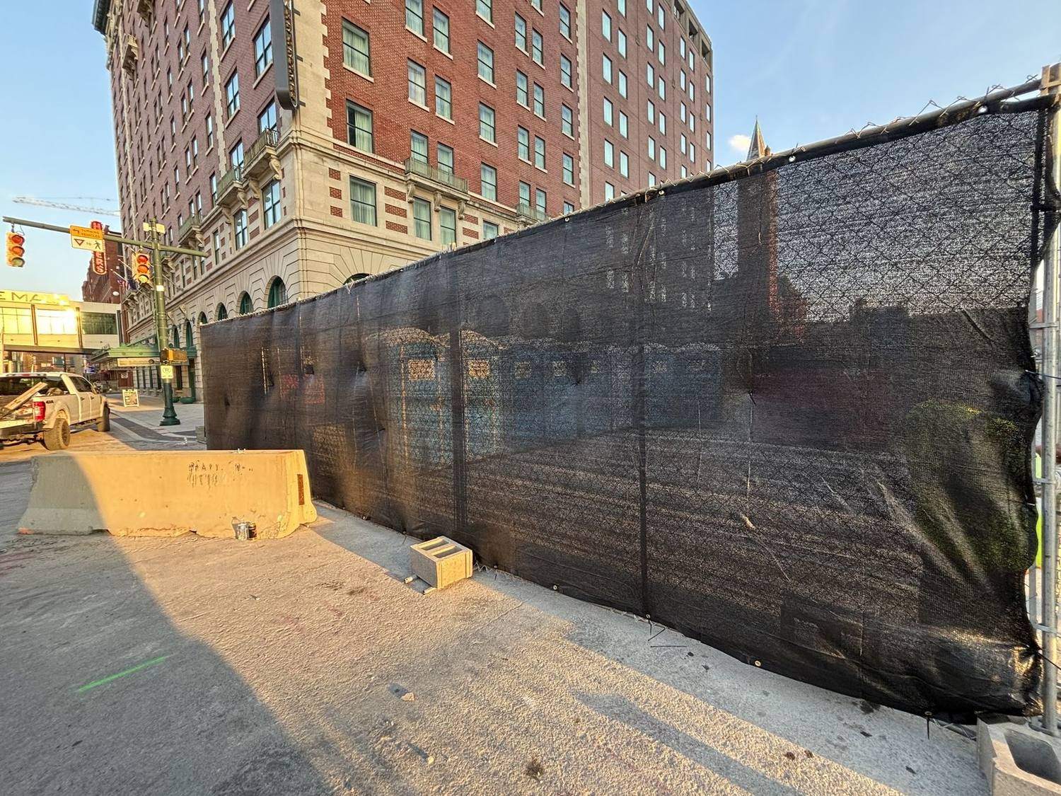 Windscreen on temporary fence running along the base of a downtown building